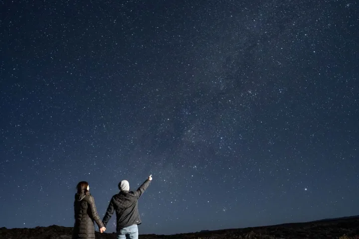 a person standing on top of a grass covered field