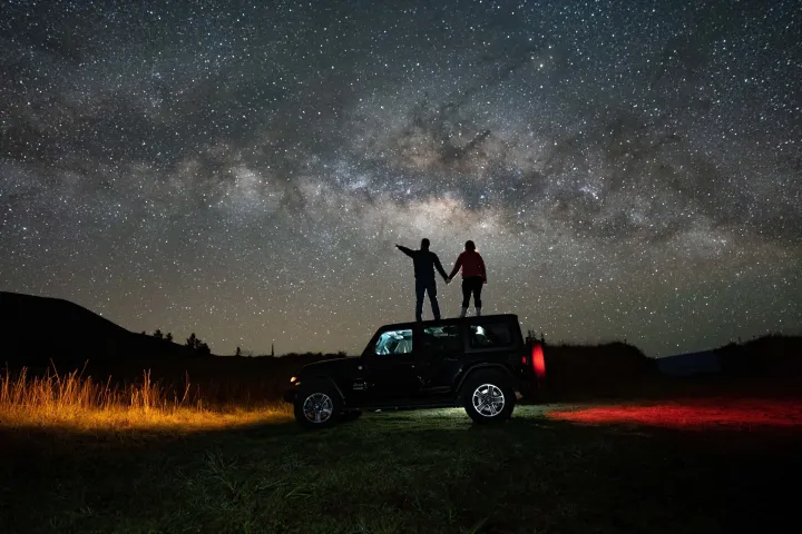 a man that is standing in the grass